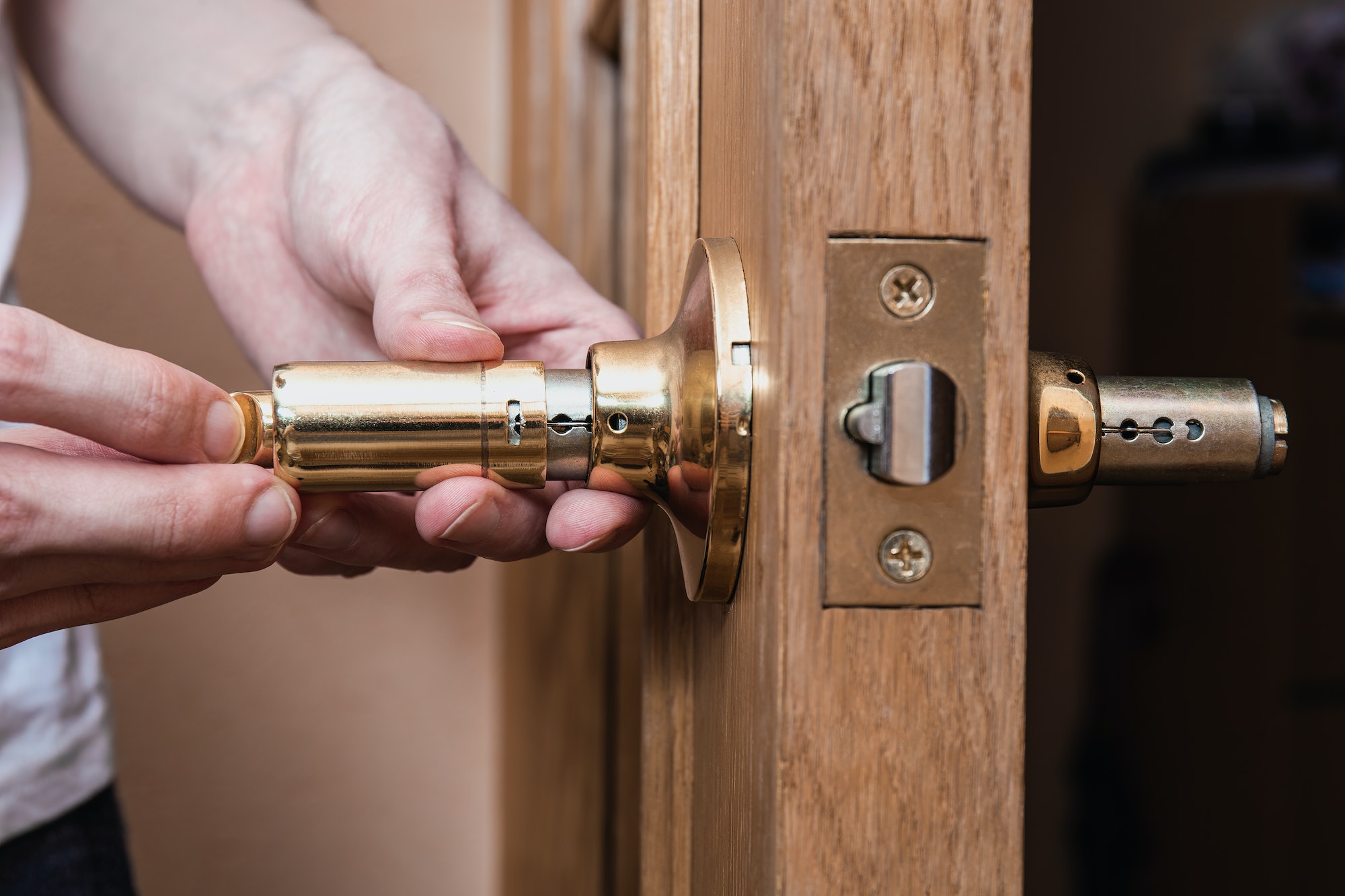 locksmith carpenter fix knob on wooden door by screwdriver for home service reparation.